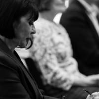 A black and white photo of President Mantella taking notes